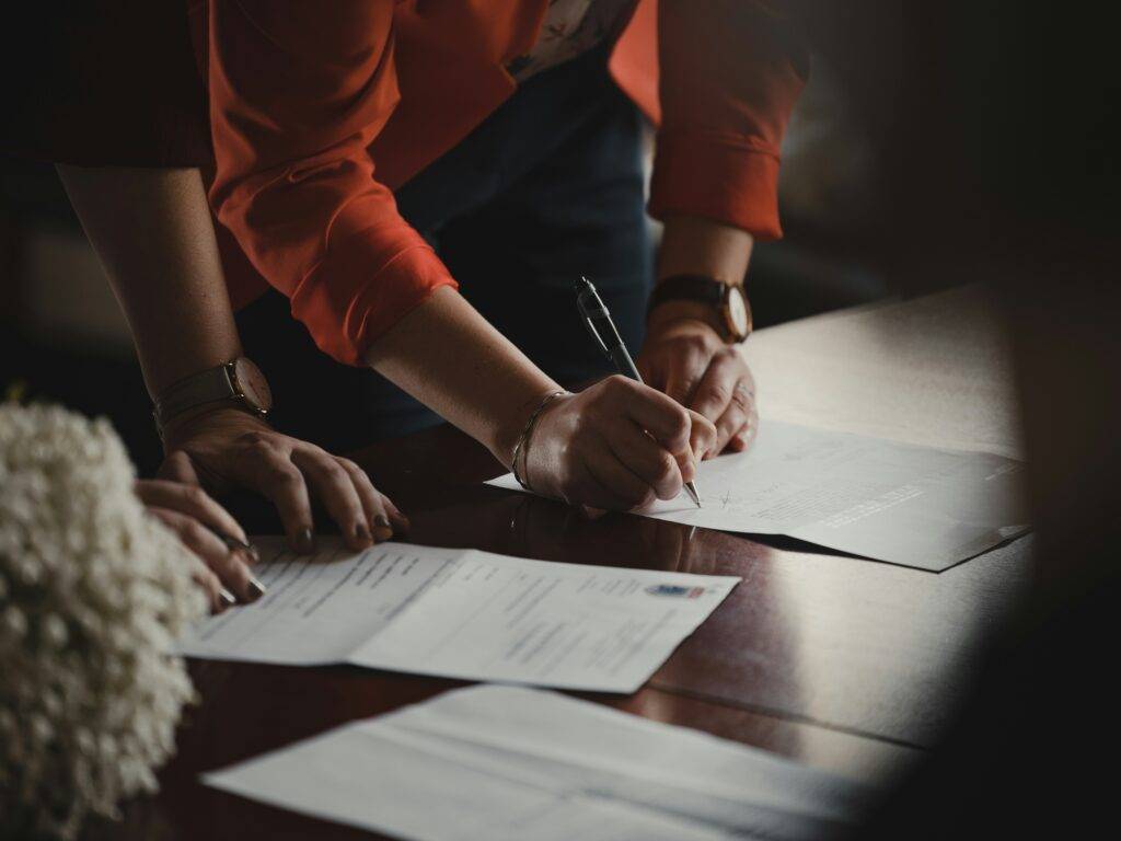 People signing legal documents