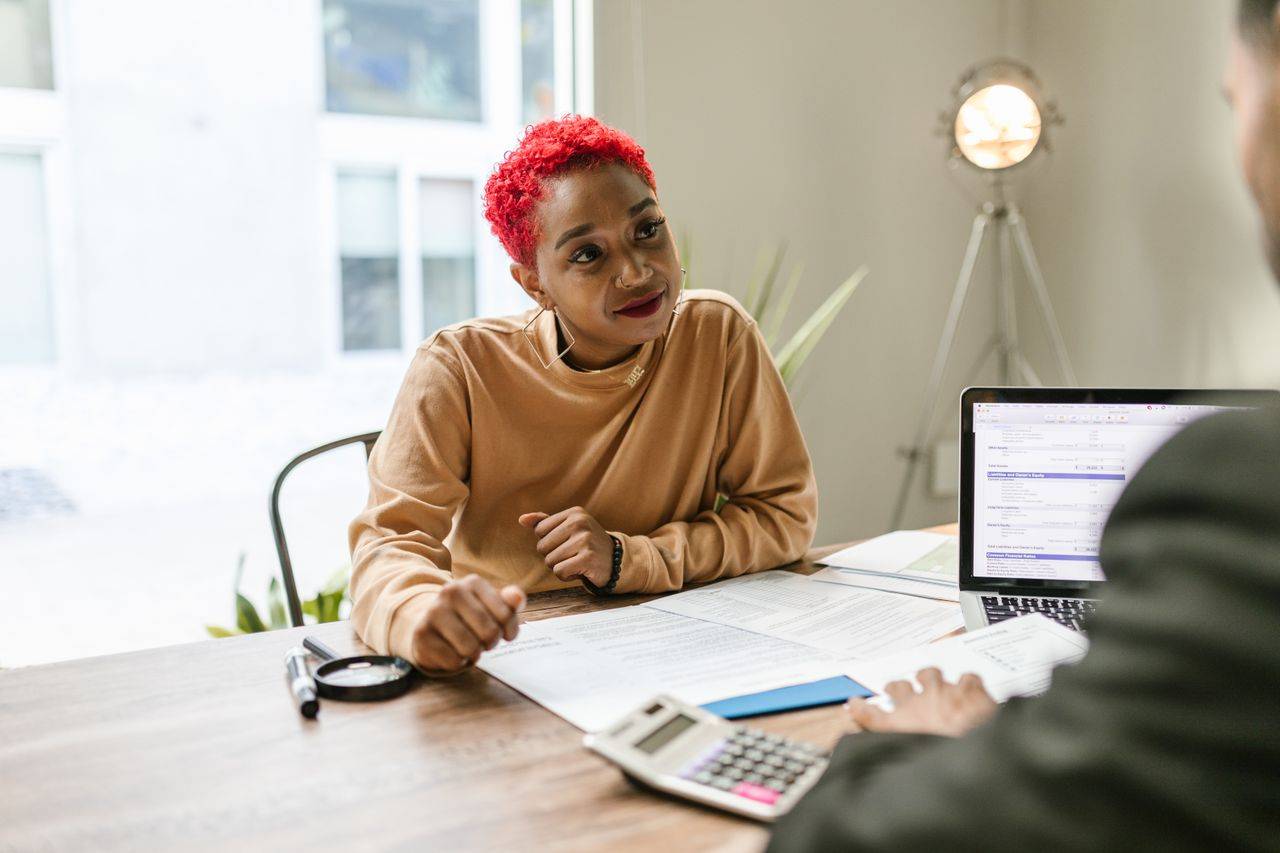 Woman receiving advice at a desk. 